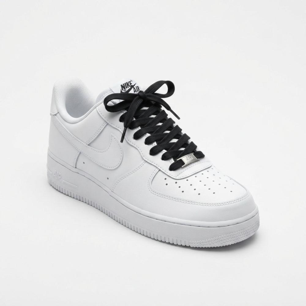 Studio product shot of a white Nike Air Force 1 Low sneaker featuring black premium flat laces tied in a classic bow, angled at 3/4 view on a clean light grey background.